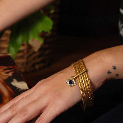 Evil Eye Gold Plated Set of Bangles with floral texture. Blue Rhinestone All Seeing Eye.