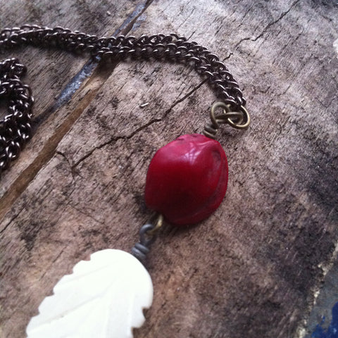 White Carved Bone Feather Bead with red seed pod on copper chain