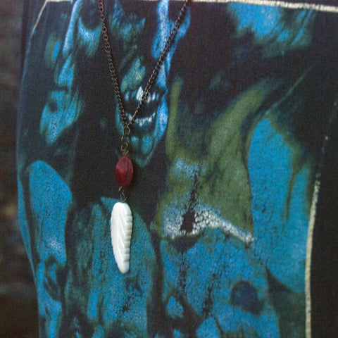 White Carved Bone Feather Bead with red seed pod on copper chain